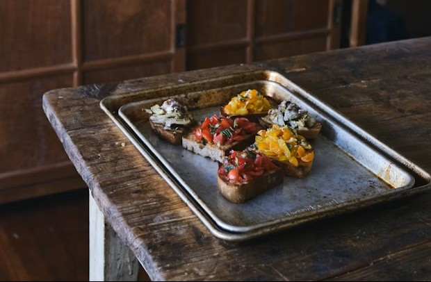 Tray of bruschetta on wooden table